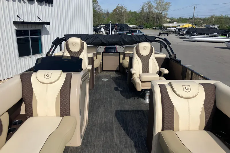 Slide: The Image of 2023 Godfrey Monaco 255 SB pontoon boat with luxurious beige and brown seating. - 26