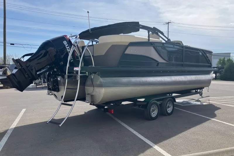 Slide: The Image of 2023 Godfrey Monaco 255 SB pontoon boat on trailer in parking lot. - 3