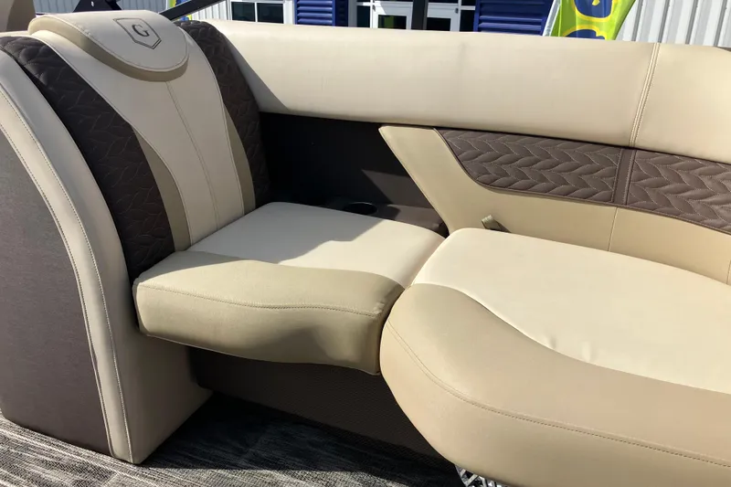 Slide: The Image of Luxurious seating on 2023 Godfrey Monaco 255 SB boat, featuring beige and brown upholstery. - 7