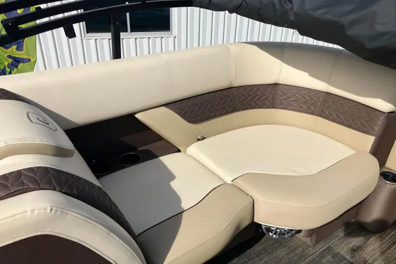 Slide: The Image of Luxurious seating on 2023 Godfrey Monaco 255 SB pontoon boat, featuring beige and brown upholstery. - 8