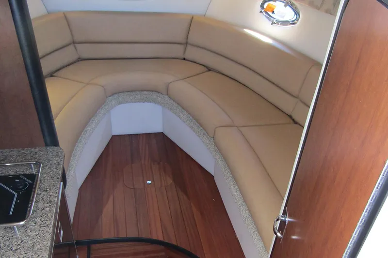 Slide: The Image of The forward lounge offers ample seating typically not available in a cruiser of this size. Insert the dining table for mealtimes. This dinette area also converts to create a comfortable double berth for sleeping. - 6
