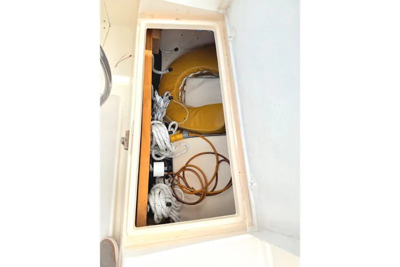 Slide: The Image of Storage compartment on 1984 Island Packet boat with ropes and life preserver. - 10
