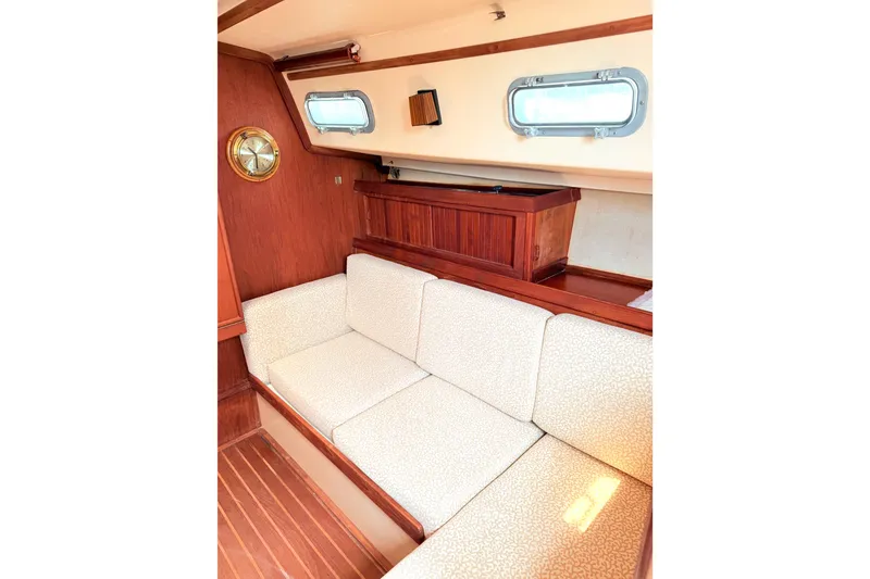 Slide: The Image of 1984 Island Packet interior with wooden accents and cushioned seating. - 20