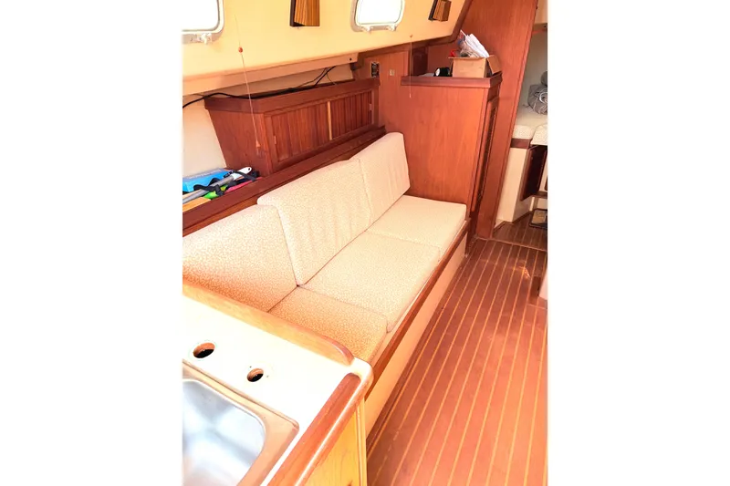 Slide: The Image of 1984 Island Packet boat interior with wooden flooring and cushioned seating. - 23