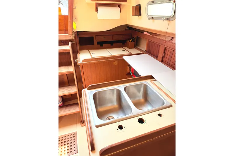 Slide: The Image of 1984 Island Packet boat interior kitchen with double sink and wooden cabinetry. - 27