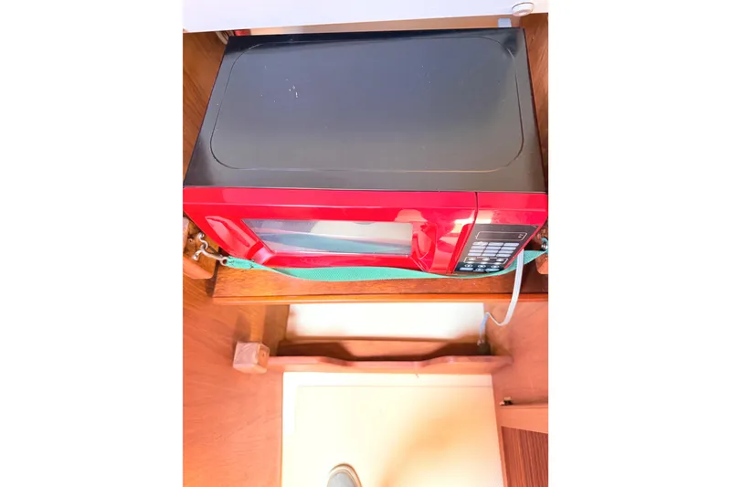 Slide: The Image of Red microwave in a 1984 Island Packet boat interior. - 30