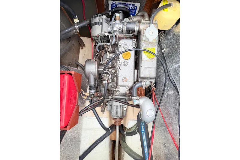 Slide: The Image of 1984 Island Packet engine with visible wiring and components in a boat compartment. - 32