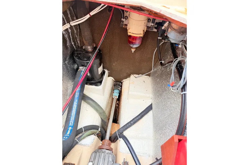 Slide: The Image of Engine compartment of a 1984 Island Packet boat, showing hoses and fuel filter. - 39