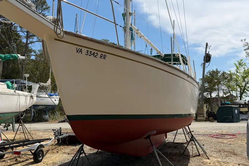 Slide: The Image of 1984 Island Packet sailboat on dry dock, registration VA 3342 RR, under clear sky. - 41