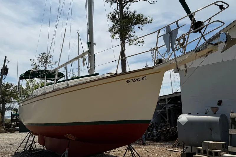 Slide: The Image of 1984 Island Packet sailboat on dry dock, with visible registration number VA 3342 RR. - 44