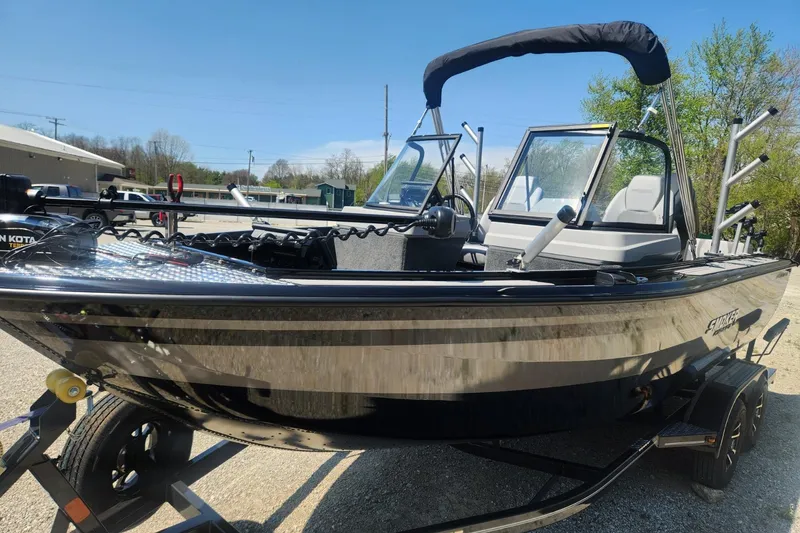 Slide: The Image of 2026 Smoker Craft Adventurer 210 GLS Sport boat on trailer, sunny day, outdoor setting. - 14
