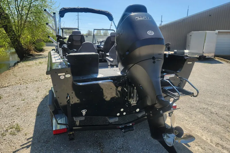 Slide: The Image of 2026 Smoker Craft Adventurer 210 GLS Sport boat with powerful outboard motor, parked outdoors. - 16
