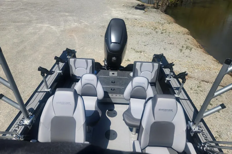 Slide: The Image of 2026 Smoker Craft Adventurer 210 GLS Sport boat interior with seating and motor. - 18