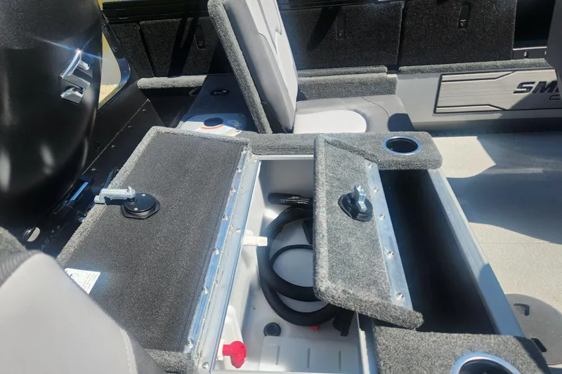 Slide: The Image of 2026 Smoker Craft Adventurer 210 GLS Sport boat interior with open storage compartment. - 19