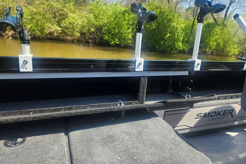 Slide: The Image of 2026 Smoker Craft Adventurer 210 GLS Sport boat interior with rod holders and storage. - 21