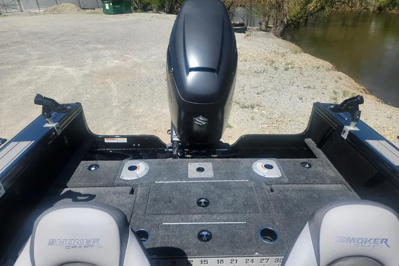 Slide: The Image of 2026 Smoker Craft Adventurer 210 GLS Sport boat interior with motor, seats, and fishing deck. - 22