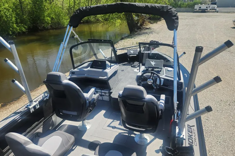 Slide: The Image of 2026 Smoker Craft Adventurer 210 GLS Sport boat interior by a riverbank. - 23