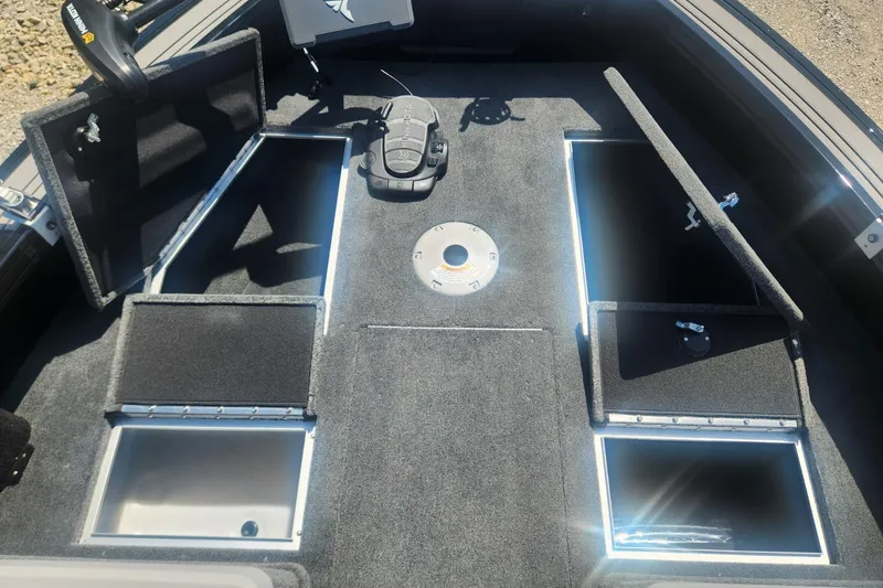 Slide: The Image of 2026 Smoker Craft Adventurer 210 GLS Sport boat interior with open storage compartments. - 28