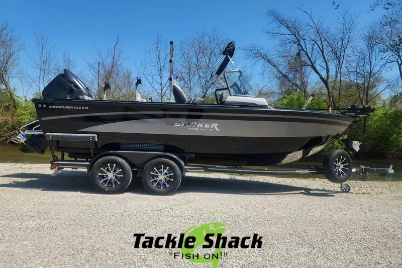 Slide: The Image of 2026 Smoker Craft Adventurer 210 GLS Sport boat on trailer, parked near a river. - 7