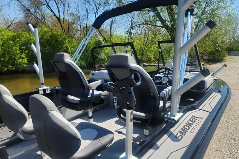 Slide: The Image of 2026 Smoker Craft Adventurer 210 GLS Sport boat interior with seating and rod holders. - 9
