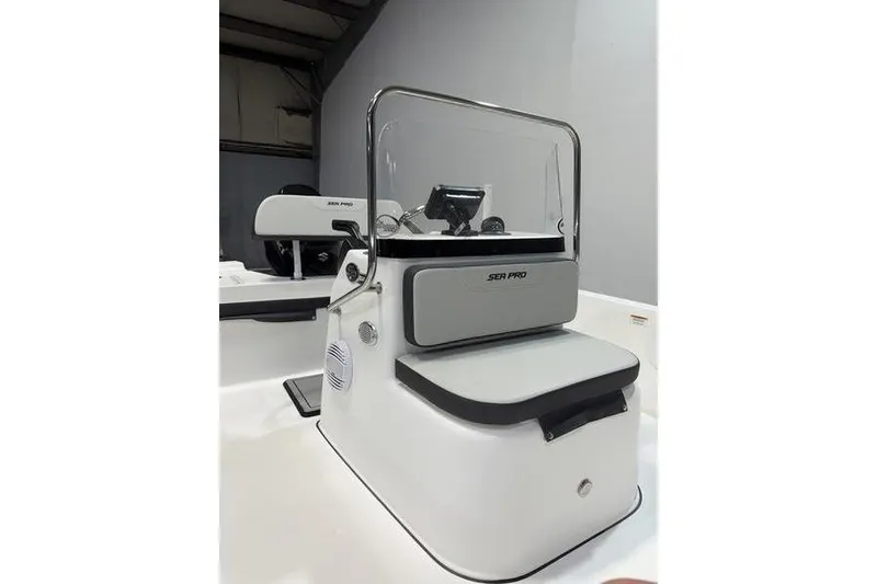 Slide: The Image of 2026 Sea Pro 172 Bay boat console with windshield and seating in a showroom. - 12