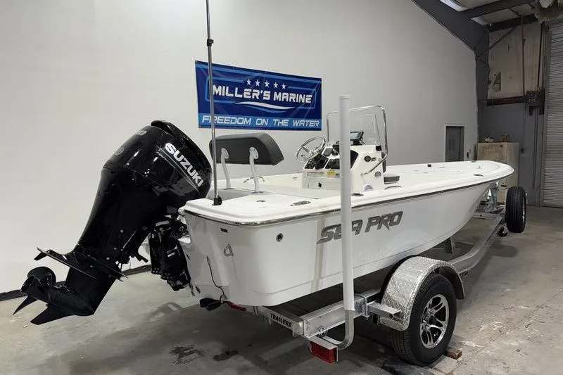 Slide: The Image of 2026 Sea Pro 172 Bay boat with Suzuki outboard motor on trailer in showroom. - 2