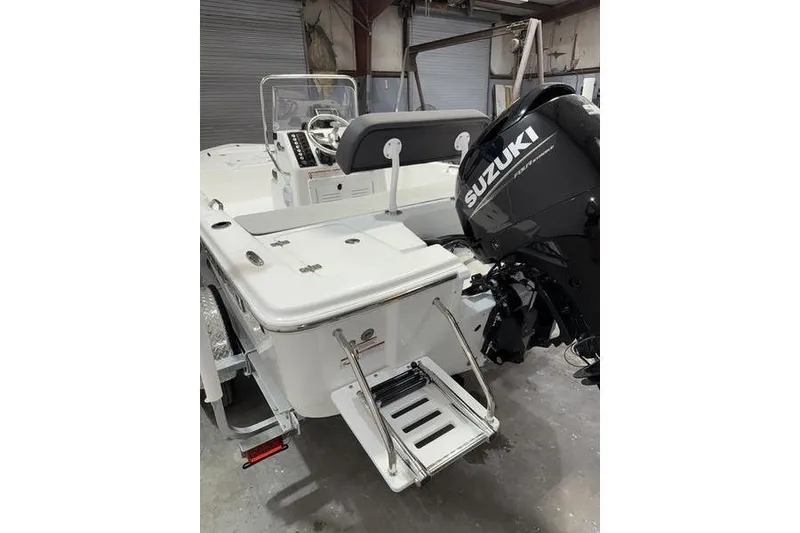 Slide: The Image of 2026 Sea Pro 172 Bay boat with Suzuki outboard motor in a garage setting. - 4