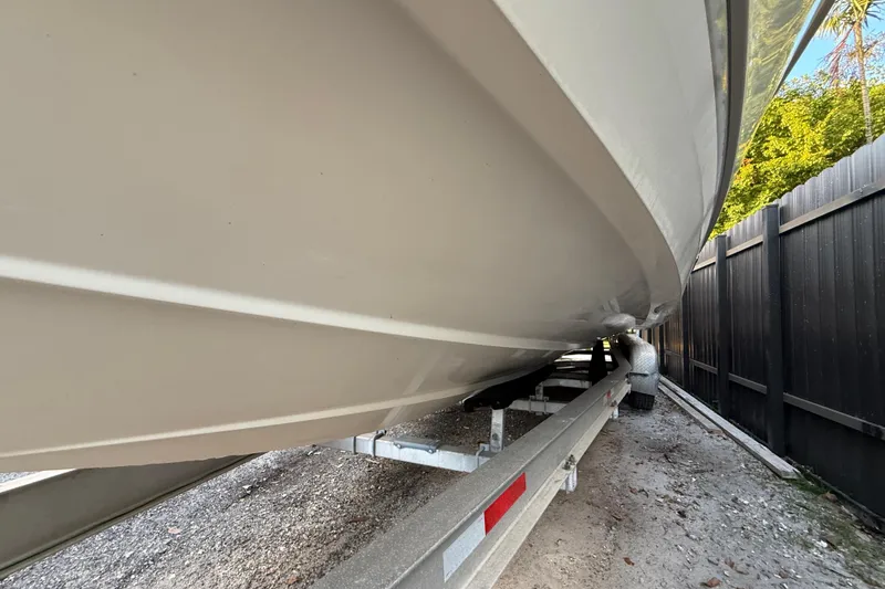 Slide: The Image of 2004 Wellcraft 32 CCF boat on trailer, side view, parked outdoors. - 14