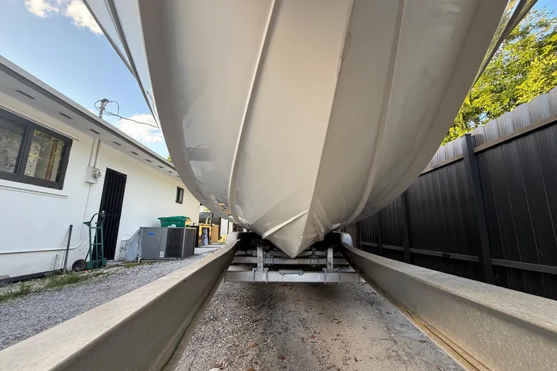 Slide: The Image of 2004 Wellcraft 32 CCF boat on trailer, parked beside a building. - 16