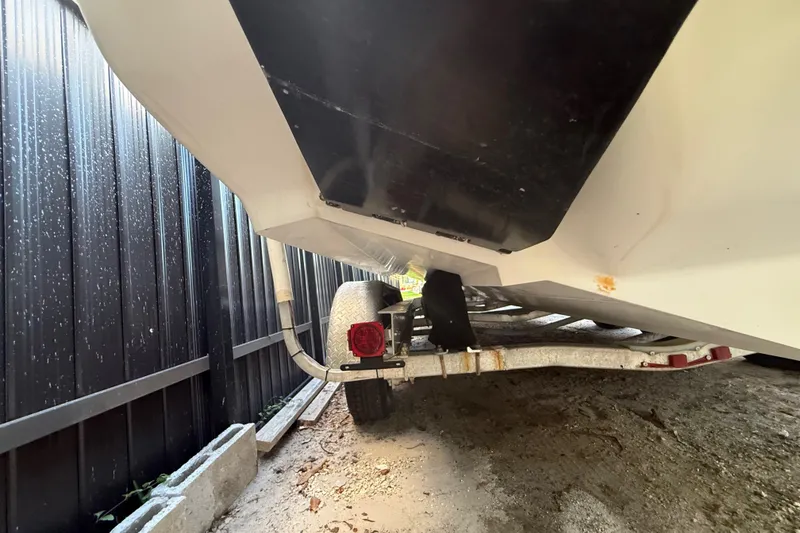 Slide: The Image of Underneath view of a 2004 Wellcraft 32 CCF boat on a trailer. - 23