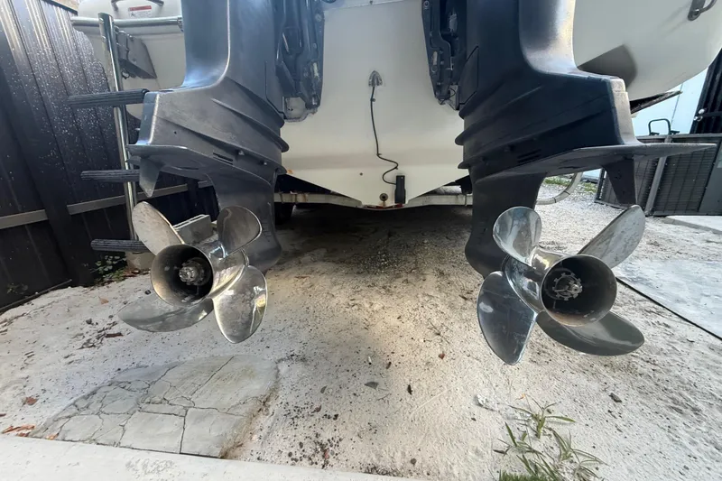 Slide: The Image of 2004 Wellcraft 32 CCF boat propellers on sandy ground, rear view. - 29