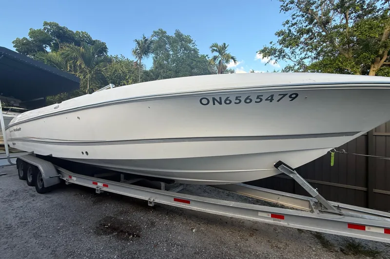Slide: The Image of 2004 Wellcraft 32 CCF boat on trailer, surrounded by trees and clear sky. - 3