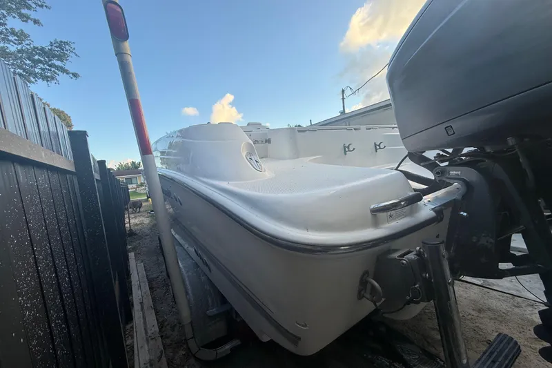 Slide: The Image of 2004 Wellcraft 32 CCF boat parked outdoors, side view with motor visible. - 33