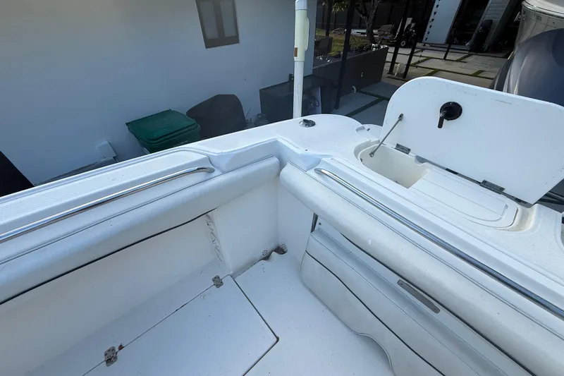 Slide: The Image of 2004 Wellcraft 32 CCF boat interior, featuring white seating and storage compartments. - 37