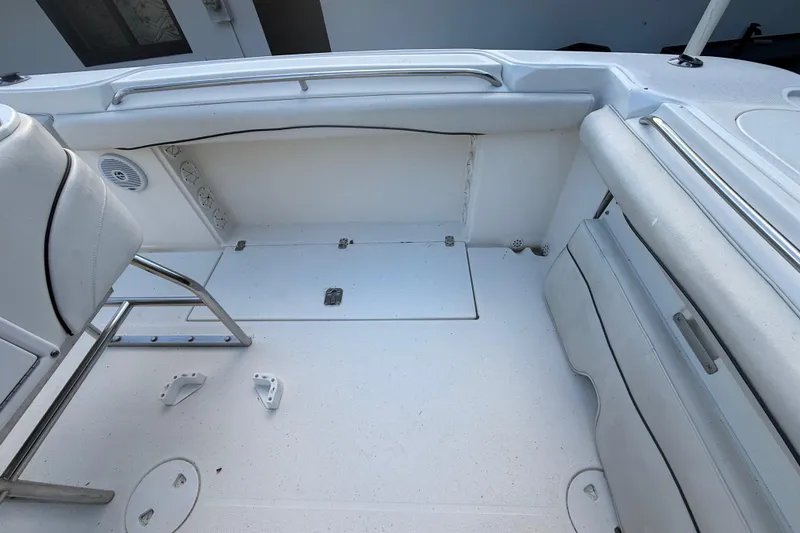 Slide: The Image of 2004 Wellcraft 32 CCF boat interior, featuring white seating and storage compartments. - 39