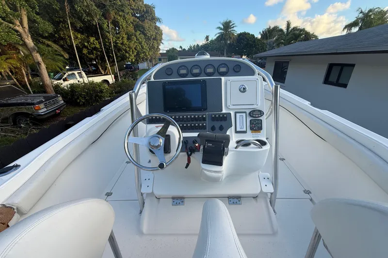Slide: The Image of 2004 Wellcraft 32 CCF boat cockpit with steering wheel and control panel. - 43