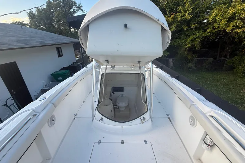 Slide: The Image of 2004 Wellcraft 32 CCF boat interior with open hatch and visible toilet. - 48