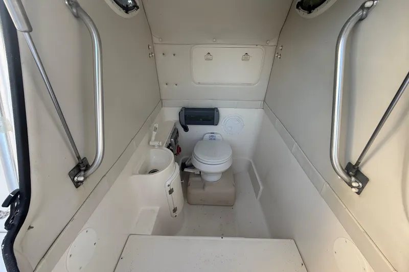 Slide: The Image of 2004 Wellcraft 32 CCF boat interior with compact marine toilet and sink. - 49