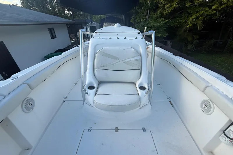 Slide: The Image of 2004 Wellcraft 32 CCF boat interior with white seating and cup holders. - 53