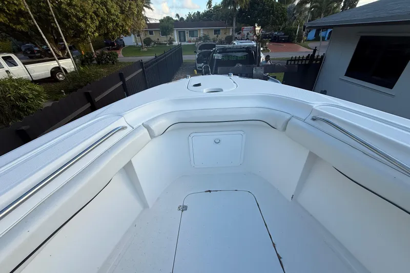 Slide: The Image of 2004 Wellcraft 32 CCF boat interior, featuring spacious white seating and storage compartments. - 57