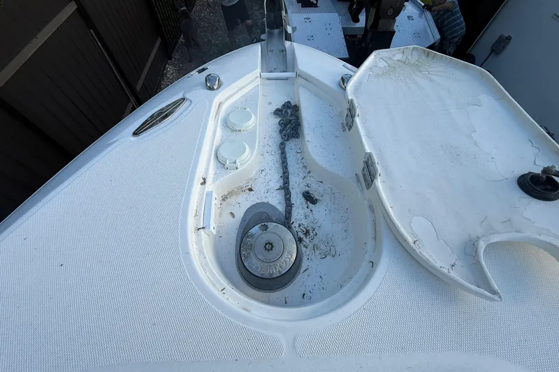 Slide: The Image of 2004 Wellcraft 32 CCF boat anchor compartment with chain and winch. - 58