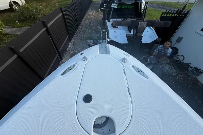 Slide: The Image of 2004 Wellcraft 32 CCF boat on trailer, parked beside a fence. - 59
