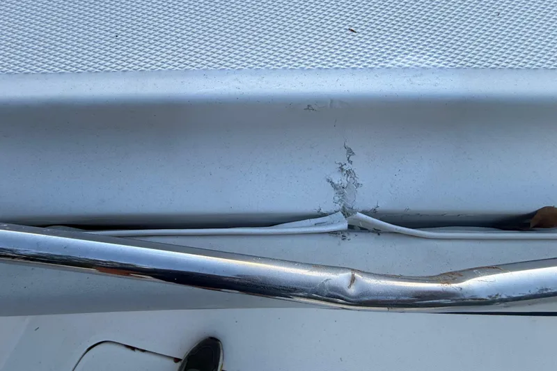 Slide: The Image of Damaged railing and fiberglass on 2004 Wellcraft 32 CCF boat. - 64