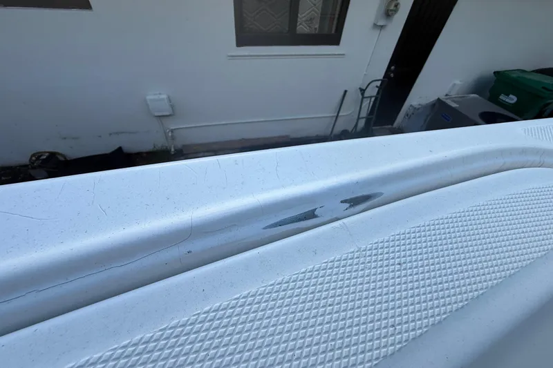 Slide: The Image of Close-up of 2004 Wellcraft 32 CCF boat surface with textured grip and visible wear. - 66