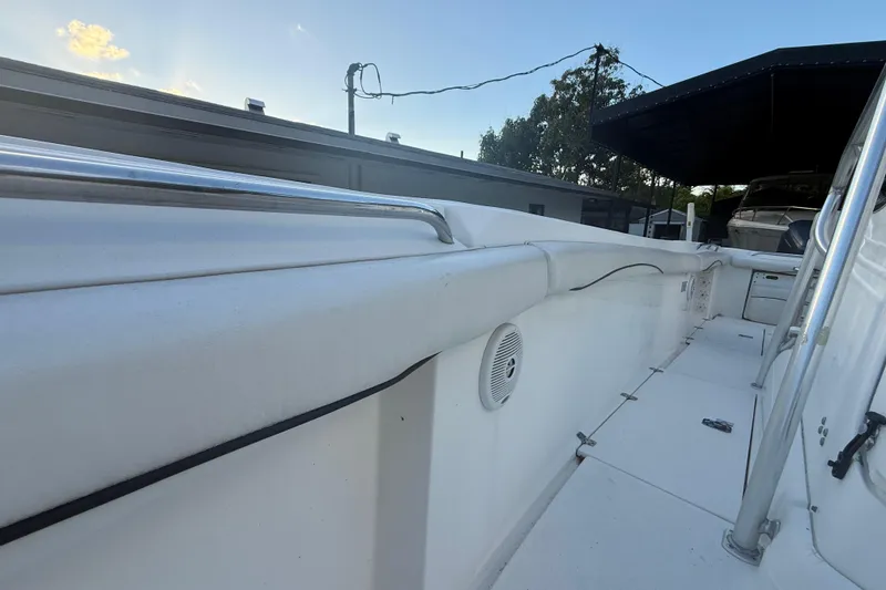 Slide: The Image of 2004 Wellcraft 32 CCF boat deck with railing and speaker, under a clear sky. - 67
