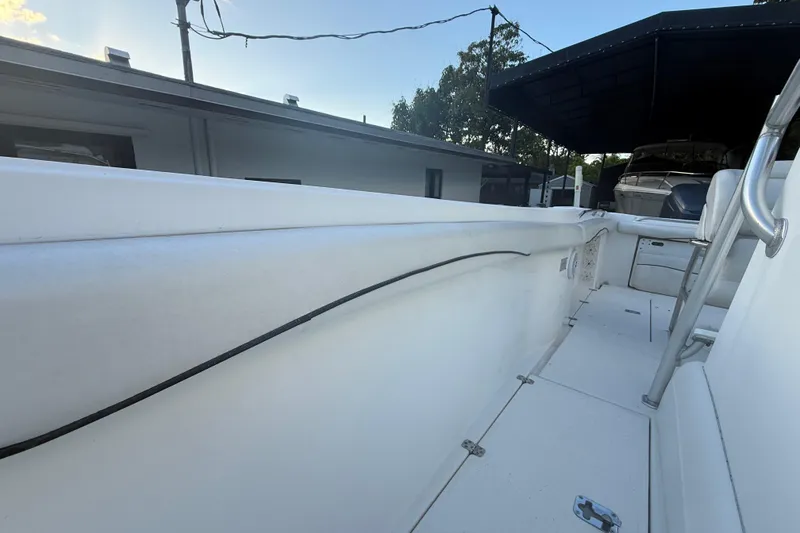 Slide: The Image of 2004 Wellcraft 32 CCF boat interior, showcasing sleek white deck and seating area. - 68