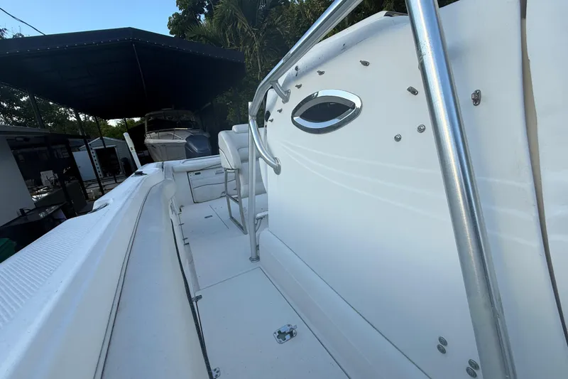 Slide: The Image of 2004 Wellcraft 32 CCF boat interior with seating and railing, under covered storage. - 69