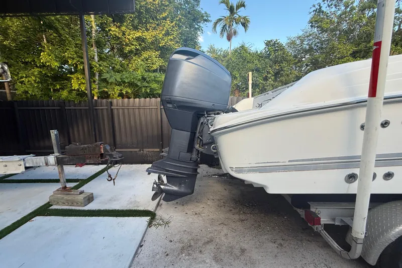 Slide: The Image of 2004 Wellcraft 32 CCF boat on trailer, outboard motor visible, parked outdoors. - 7