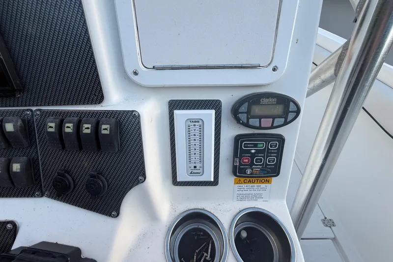 Slide: The Image of Control panel of a 2004 Wellcraft 32 CCF boat with switches and gauges. - 71