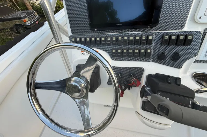 Slide: The Image of 2004 Wellcraft 32 CCF boat dashboard with steering wheel and control panel. - 74